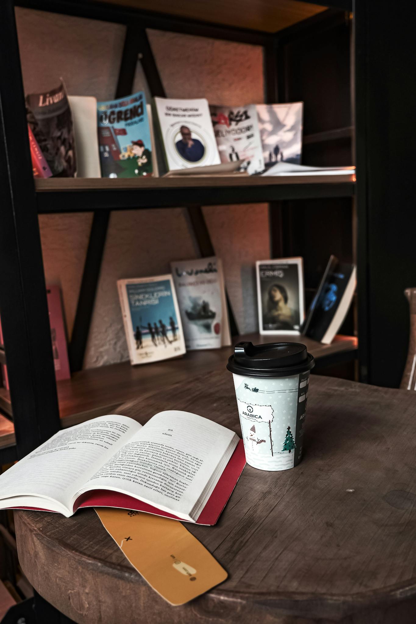 A warm, inviting reading corner with an open book and a cup of coffee on a wooden table.