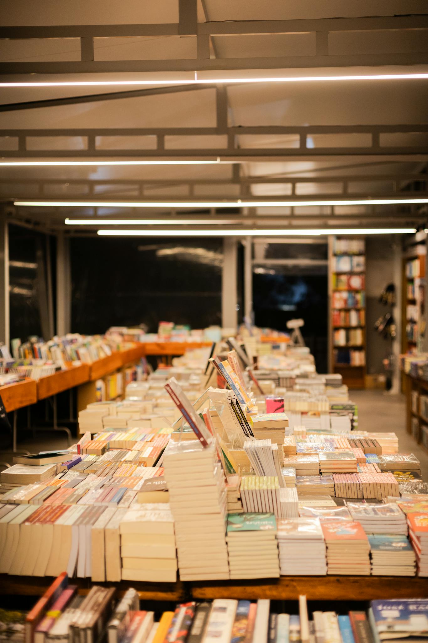 Explore a warm bookstore in São Paulo with neatly stacked books and inviting ambiance.